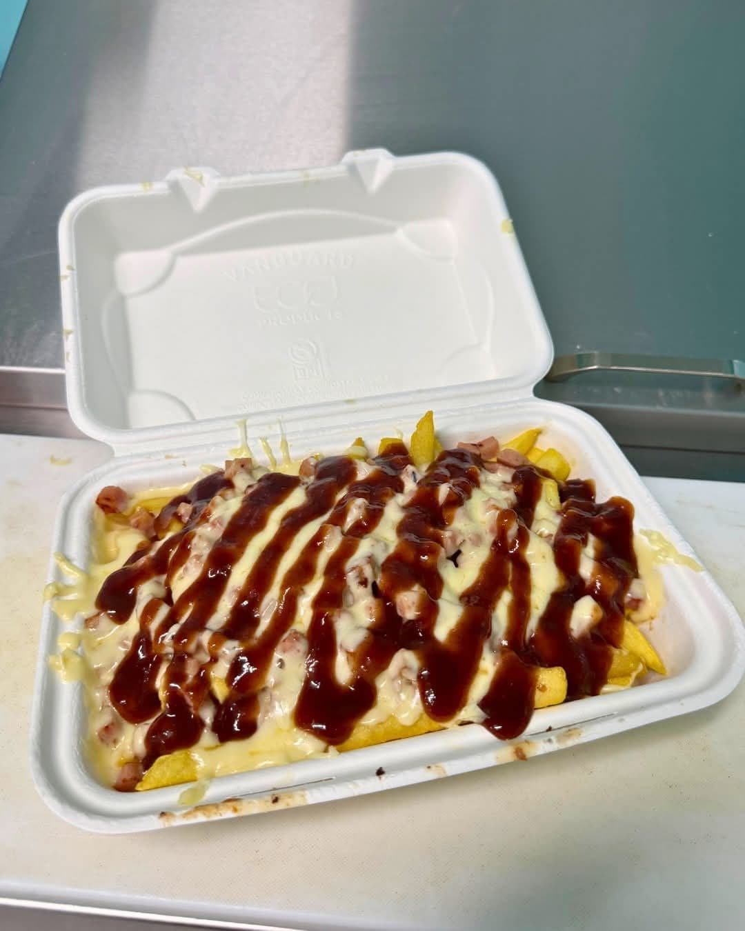 Loaded fries with sauce in a takeaway box
