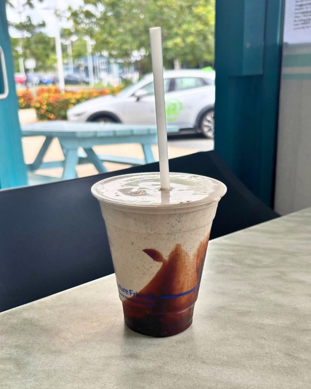 An Oreo milkshake with a straw