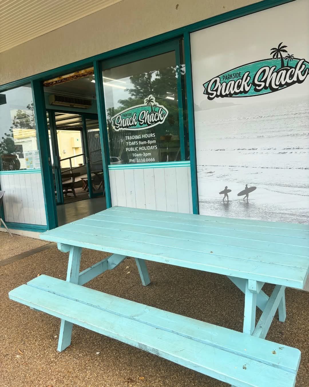 The Parkside Snack Shack shopfront and teal picnic bench in Emu Park